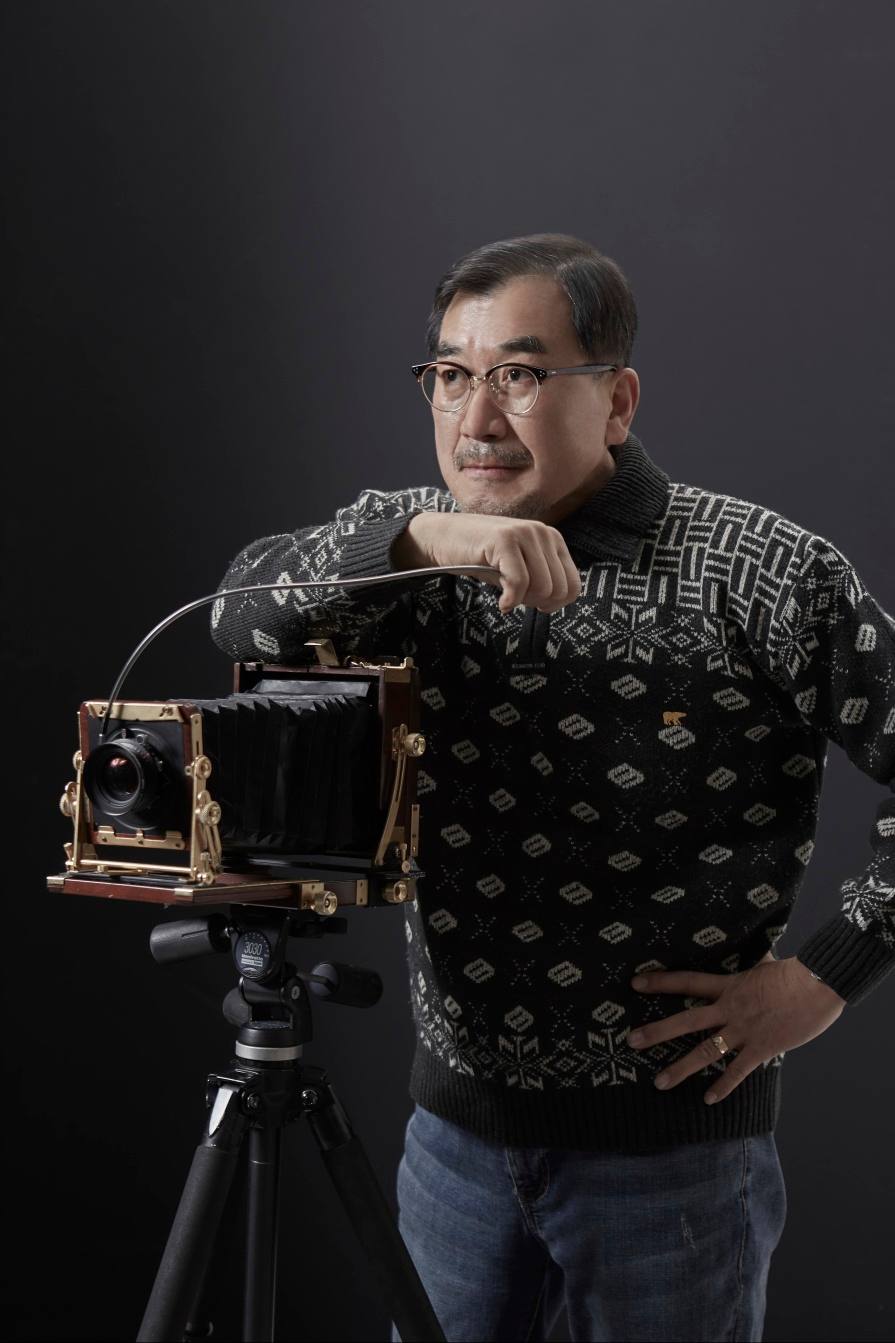 Portrait of photographer Beom Choi with his large-format film camera